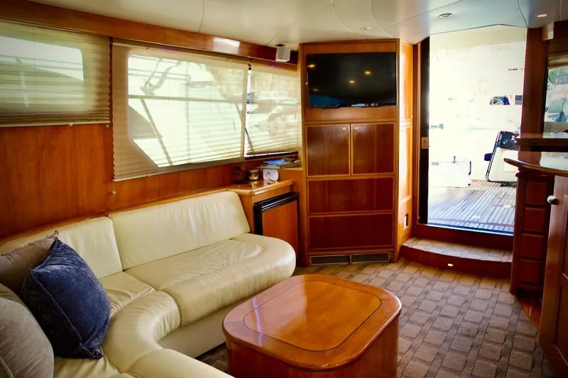 The Donut Hull Yacht Photos Pics Luxurious interior of 2002 Mikelson 50 Sportfisher yacht with leather seating and wooden finishes.