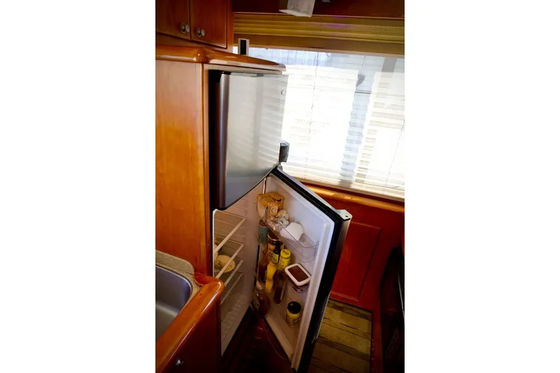 The Donut Hull Yacht Photos Pics Open refrigerator inside 2002 Mikelson 50 Sportfisher yacht kitchen area.