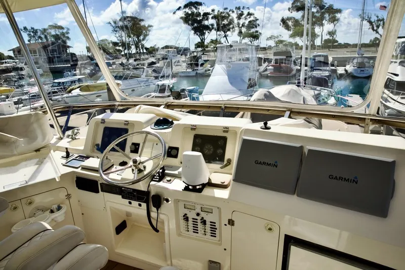The Donut Hull Yacht Photos Pics Helm of 2002 Mikelson 50 Sportfisher with Garmin navigation, docked at marina.