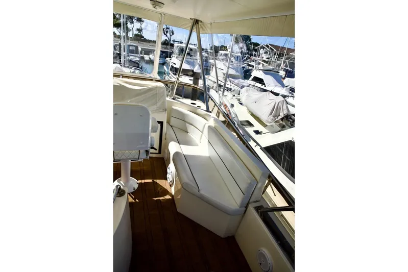 The Donut Hull Yacht Photos Pics 2002 Mikelson 50 Sportfisher yacht interior with seating and marina view.