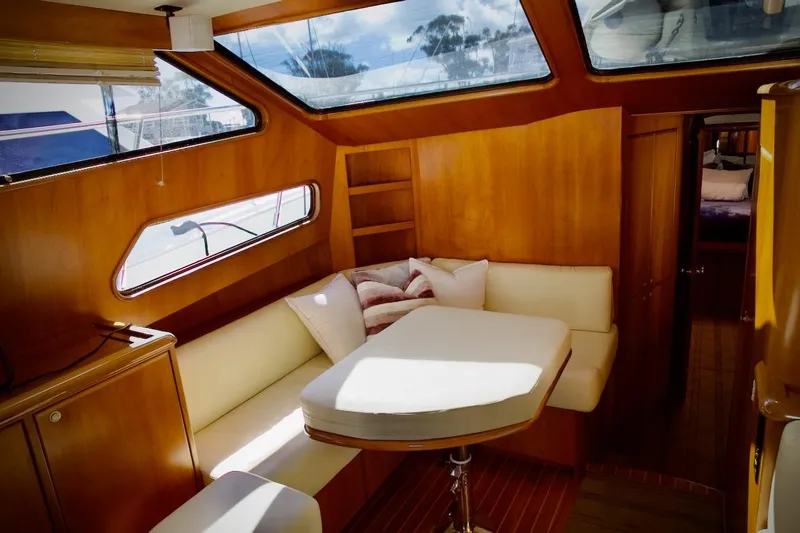 The Donut Hull Yacht Photos Pics Luxurious interior of 2002 Mikelson 50 Sportfisher yacht with cozy seating and wooden finishes.