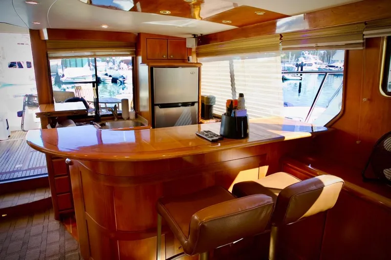 The Donut Hull Yacht Photos Pics Luxurious interior of 2002 Mikelson 50 Sportfisher yacht with bar and seating area.