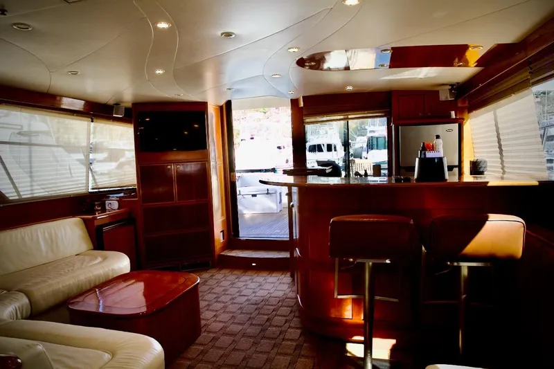 The Donut Hull Yacht Photos Pics Luxurious interior of a 2002 Mikelson 50 Sportfisher yacht with elegant wood finishes.