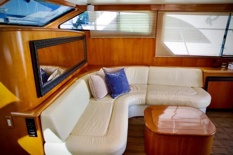 The Donut Hull Yacht Photos Pics Luxurious interior of 2002 Mikelson 50 Sportfisher yacht with elegant seating and wooden accents.