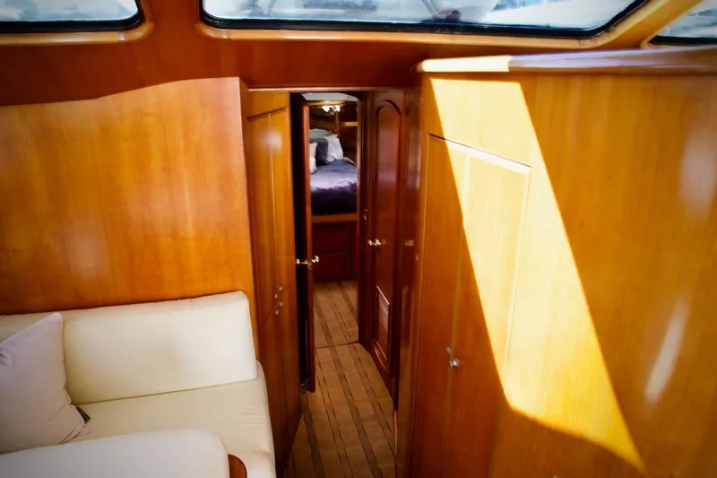 The Donut Hull Yacht Photos Pics Interior of 2002 Mikelson 50 Sportfisher yacht with wooden paneling and cozy seating.