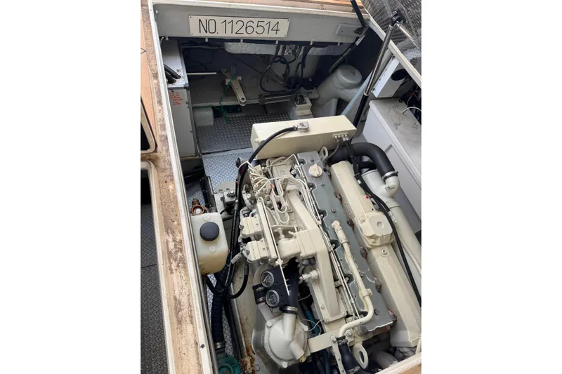 The Donut Hull Yacht Photos Pics Engine compartment of a 2002 Mikelson 50 Sportfisher boat, showcasing detailed machinery.