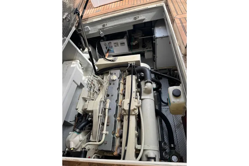 The Donut Hull Yacht Photos Pics Engine compartment of a 2002 Mikelson 50 Sportfisher yacht, showcasing detailed machinery.