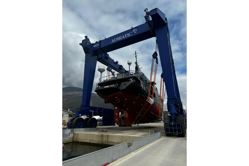 Anne S Pierce Yacht Photos Pics Large ship being lifted by blue crane at Glovertown Shipyard, 2021.