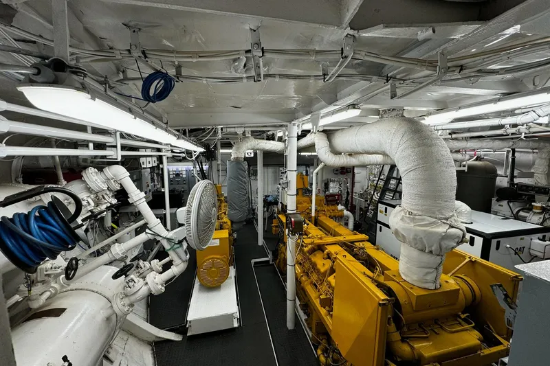 Anne S Pierce Yacht Photos Pics Engine room of a 2021 Custom Glovertown Shipyard vessel, featuring machinery and piping.