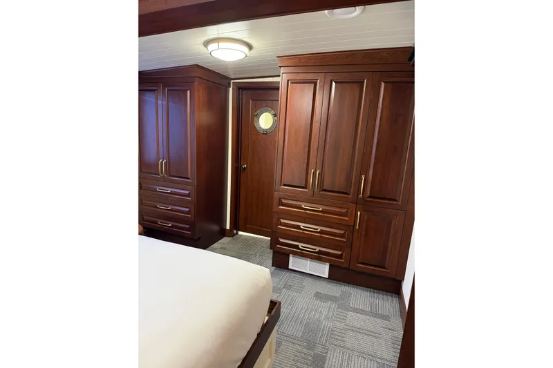 Anne S Pierce Yacht Photos Pics Luxurious wooden ship cabin interior with elegant cabinetry, Custom Glovertown Shipyard, 2021.