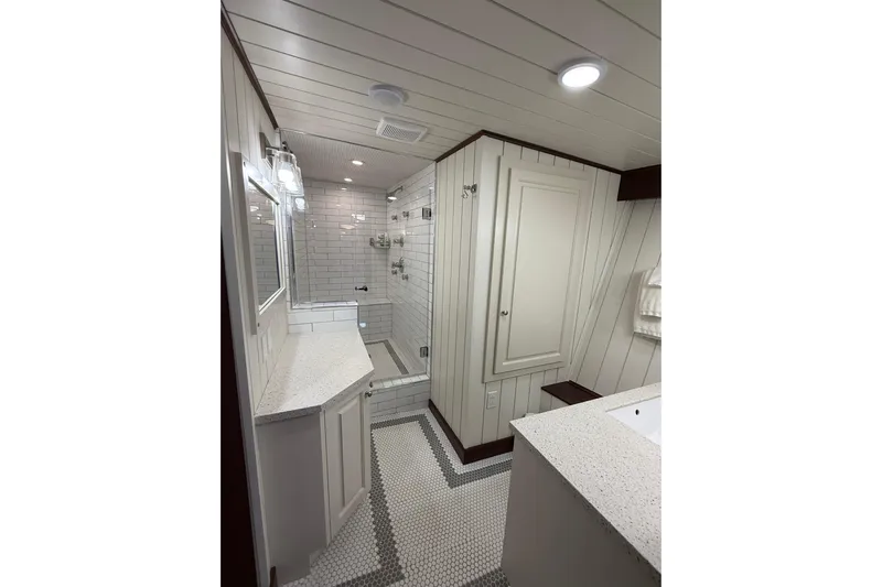 Anne S Pierce Yacht Photos Pics Luxurious 2021 Custom Glovertown Shipyard bathroom with modern white interior and elegant fixtures.