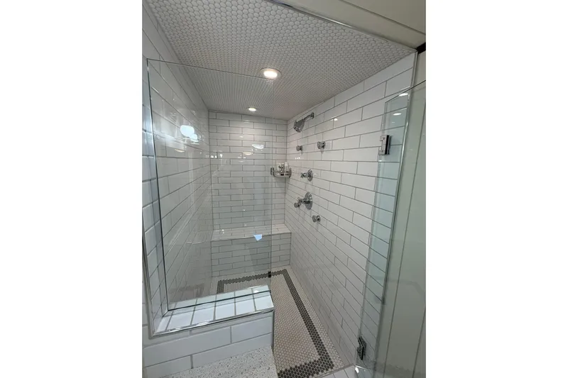 Anne S Pierce Yacht Photos Pics Modern shower with white subway tiles and glass door, Custom Glovertown Shipyard 2021 design.
