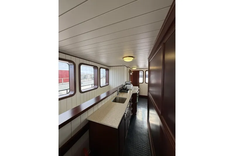 Anne S Pierce Yacht Photos Pics Interior of 2021 Custom Glovertown Shipyard with modern kitchen and large windows.