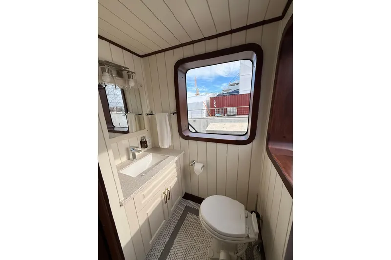 Anne S Pierce Yacht Photos Pics Modern ship bathroom with window, Custom Glovertown Shipyard 2021, featuring sink and toilet.
