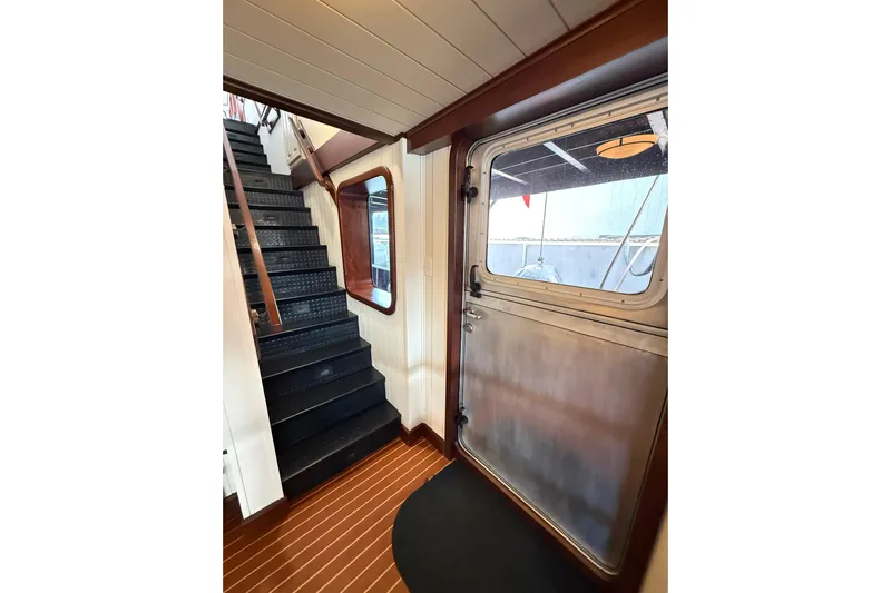 Anne S Pierce Yacht Photos Pics Interior of 2021 Custom Glovertown Shipyard with stairs and metal door.