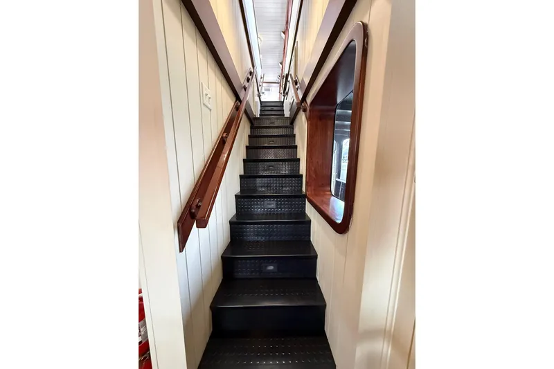Anne S Pierce Yacht Photos Pics Narrow ship staircase with wooden handrails, Custom Glovertown Shipyard, 2021 model.
