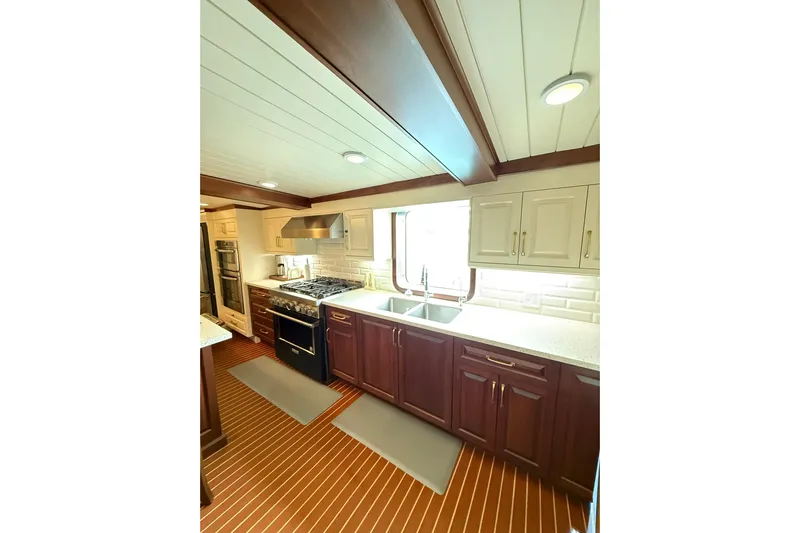Anne S Pierce Yacht Photos Pics Luxurious ship kitchen with modern appliances, wooden cabinetry, and elegant design, Glovertown Shipyard 2021.