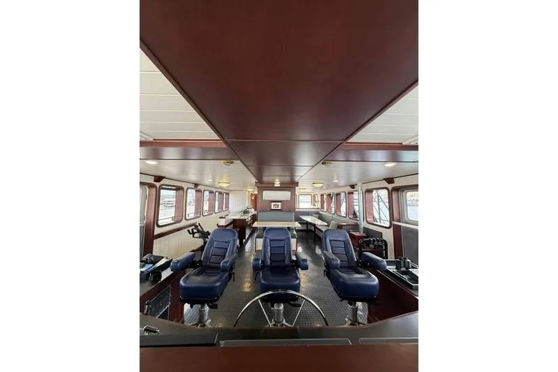 Anne S Pierce Yacht Photos Pics Interior of 2021 Custom Glovertown Shipyard vessel with blue captain chairs and panoramic windows.