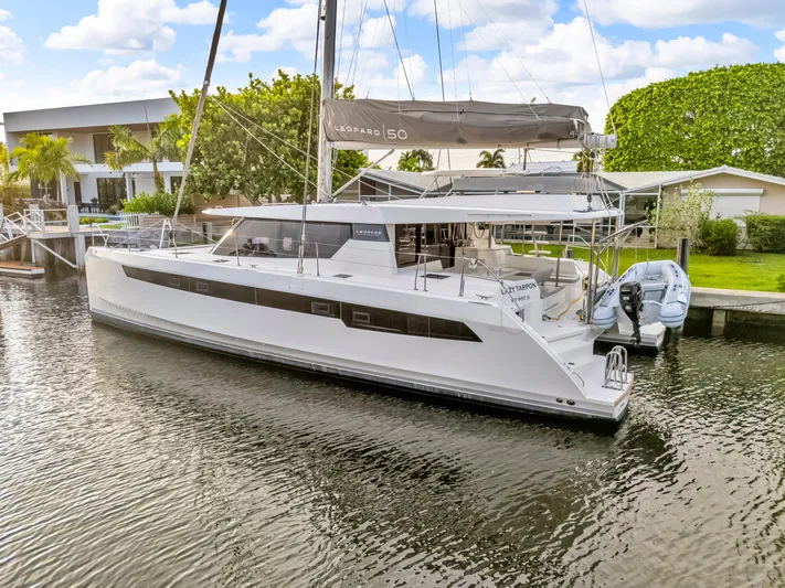  Yacht Photos Pics Luxury Leopard 50 catamaran docked in a serene marina, 2021 model.