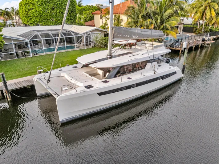  Yacht Photos Pics Luxury Leopard 50 catamaran docked by a waterfront home, 2021 model.