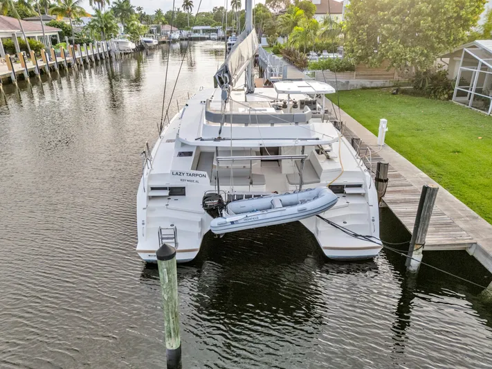  Yacht Photos Pics Leopard 50 catamaran docked in a serene canal, 2021 model.