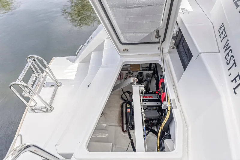  Yacht Photos Pics Open engine compartment of a 2021 Leopard 50 boat, showing mechanical components and storage area.