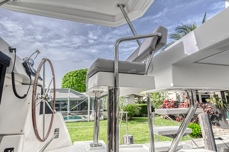  Yacht Photos Pics Helm station of 2021 Leopard 50 yacht with modern design and lush garden backdrop.