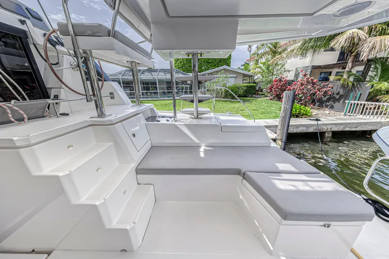  Yacht Photos Pics Leopard 50 yacht deck with seating, steps, and dock view, 2021 model.