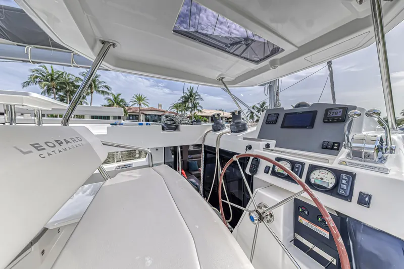  Yacht Photos Pics Helm of 2021 Leopard 50 catamaran with modern navigation equipment and tropical backdrop.