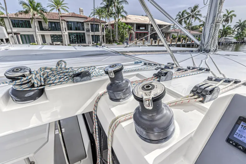 Yacht Photos Pics Sailing yacht Leopard 50 deck with winches and ropes, 2021 model, docked near waterfront homes.
