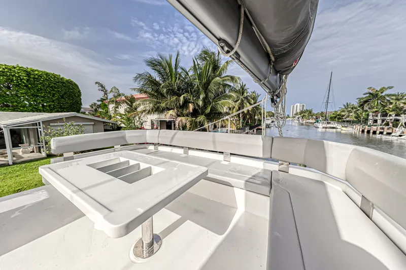  Yacht Photos Pics Leopard 50 yacht deck with seating, palm trees, and waterfront view, 2021 model.