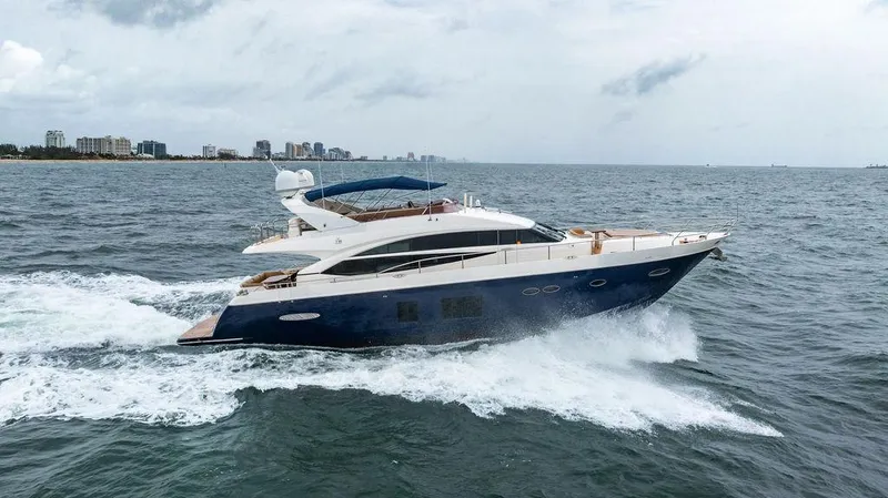  Yacht Photos Pics 2012 Princess 72 Motor Yacht cruising on open water, city skyline in background.