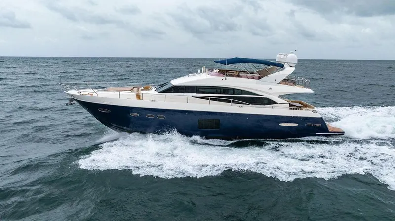  Yacht Photos Pics 2012 Princess 72 Motor Yacht cruising on open sea under cloudy skies.