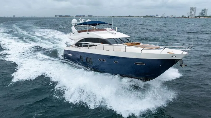  Yacht Photos Pics Luxurious 2012 Princess 72 Motor Yacht cruising on open sea under cloudy skies.