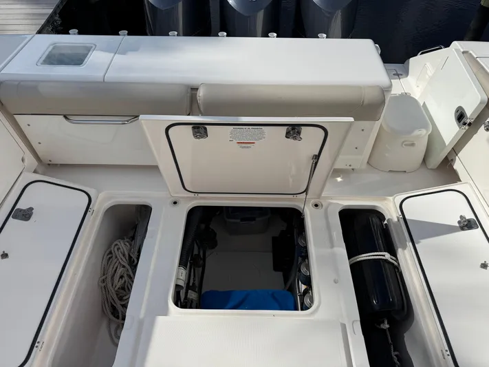  Yacht Photos Pics 2015 Pursuit OS 385 Offshore boat deck with open storage compartments and seating.