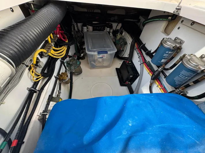 Yacht Photos Pics 2015 Pursuit OS 385 Offshore engine compartment with wiring, filters, and storage box.
