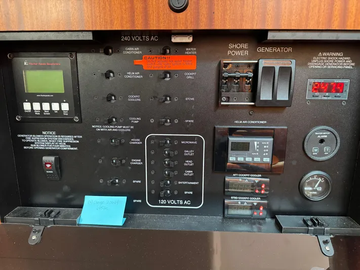  Yacht Photos Pics Electrical control panel of a 2015 Pursuit OS 385 Offshore boat, featuring various switches and gauges.