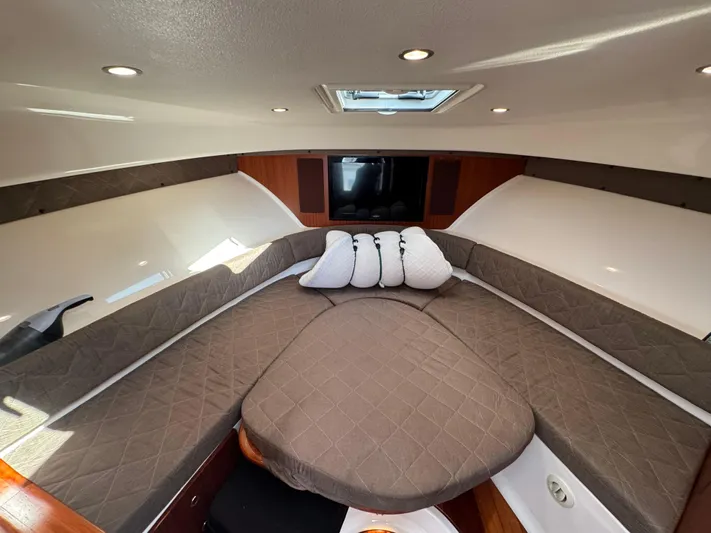  Yacht Photos Pics Luxurious interior of 2015 Pursuit OS 385 Offshore boat with cozy seating and cushions.