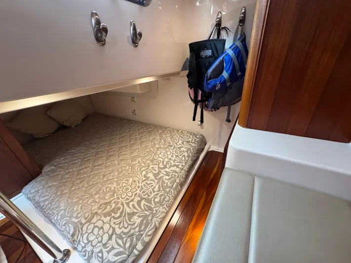  Yacht Photos Pics 2015 Pursuit OS 385 Offshore cabin with bed, hooks, and backpacks.