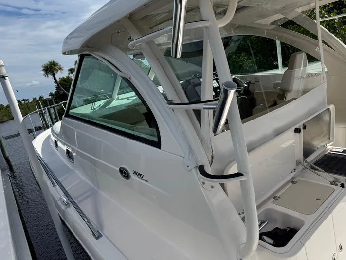  Yacht Photos Pics 2015 Pursuit OS 385 Offshore boat docked, showcasing sleek design and spacious deck.