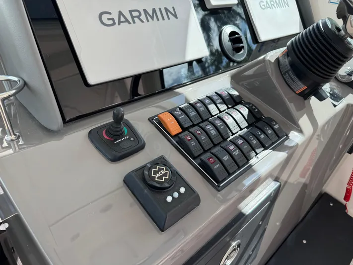  Yacht Photos Pics Control panel of 2015 Pursuit OS 385 Offshore boat with Garmin displays and joystick.
