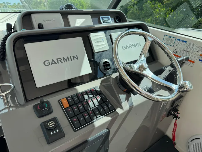  Yacht Photos Pics 2015 Pursuit OS 385 Offshore helm with Garmin navigation system and controls.