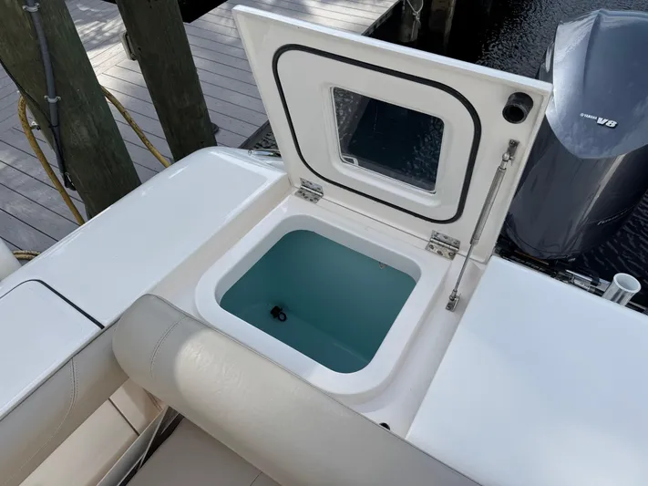  Yacht Photos Pics Open storage compartment on 2015 Pursuit OS 385 Offshore boat, docked near water.