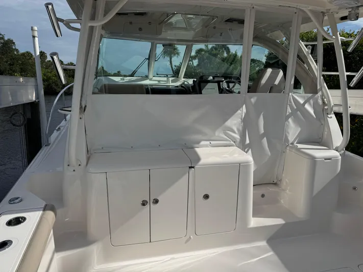  Yacht Photos Pics 2015 Pursuit OS 385 Offshore boat interior with seating and storage compartments.