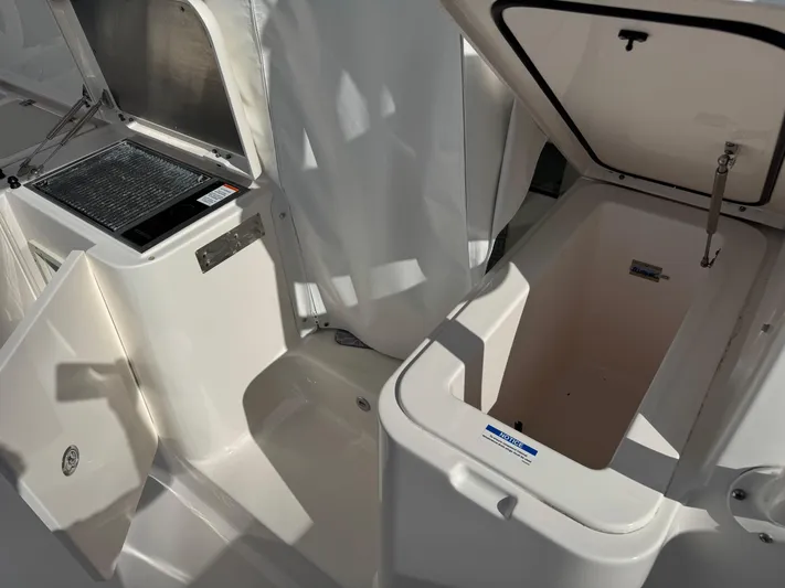  Yacht Photos Pics 2015 Pursuit OS 385 Offshore boat interior with open storage compartments.