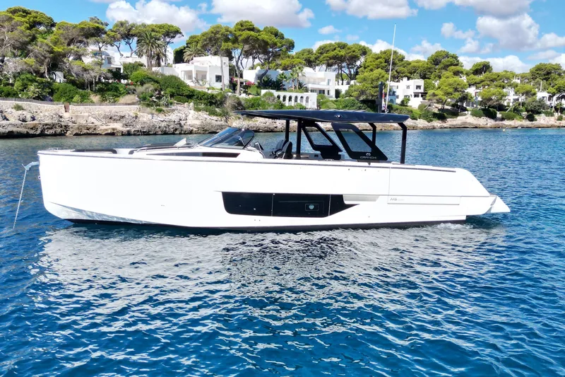  Yacht Photos Pics 2022 Cranchi A46 Luxury Tender yacht on clear blue water, coastal backdrop.