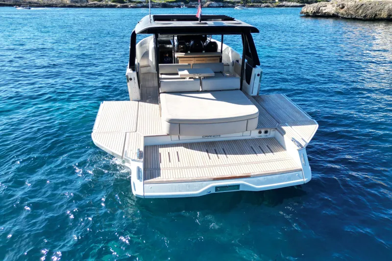  Yacht Photos Pics 2022 Cranchi A46 Luxury Tender on clear blue water, showcasing spacious deck and elegant design.