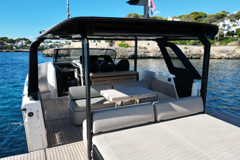  Yacht Photos Pics 2022 Cranchi A46 Luxury Tender yacht with spacious deck and seating, docked by scenic coastline.