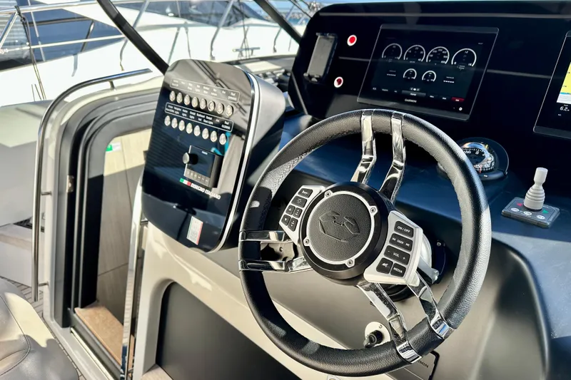  Yacht Photos Pics 2022 Cranchi A46 Luxury Tender helm with modern controls and digital displays.