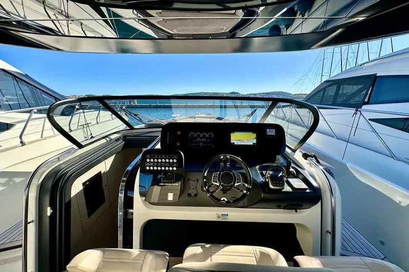  Yacht Photos Pics Cockpit view of 2022 Cranchi A46 Luxury Tender yacht, showcasing modern controls and sleek design.